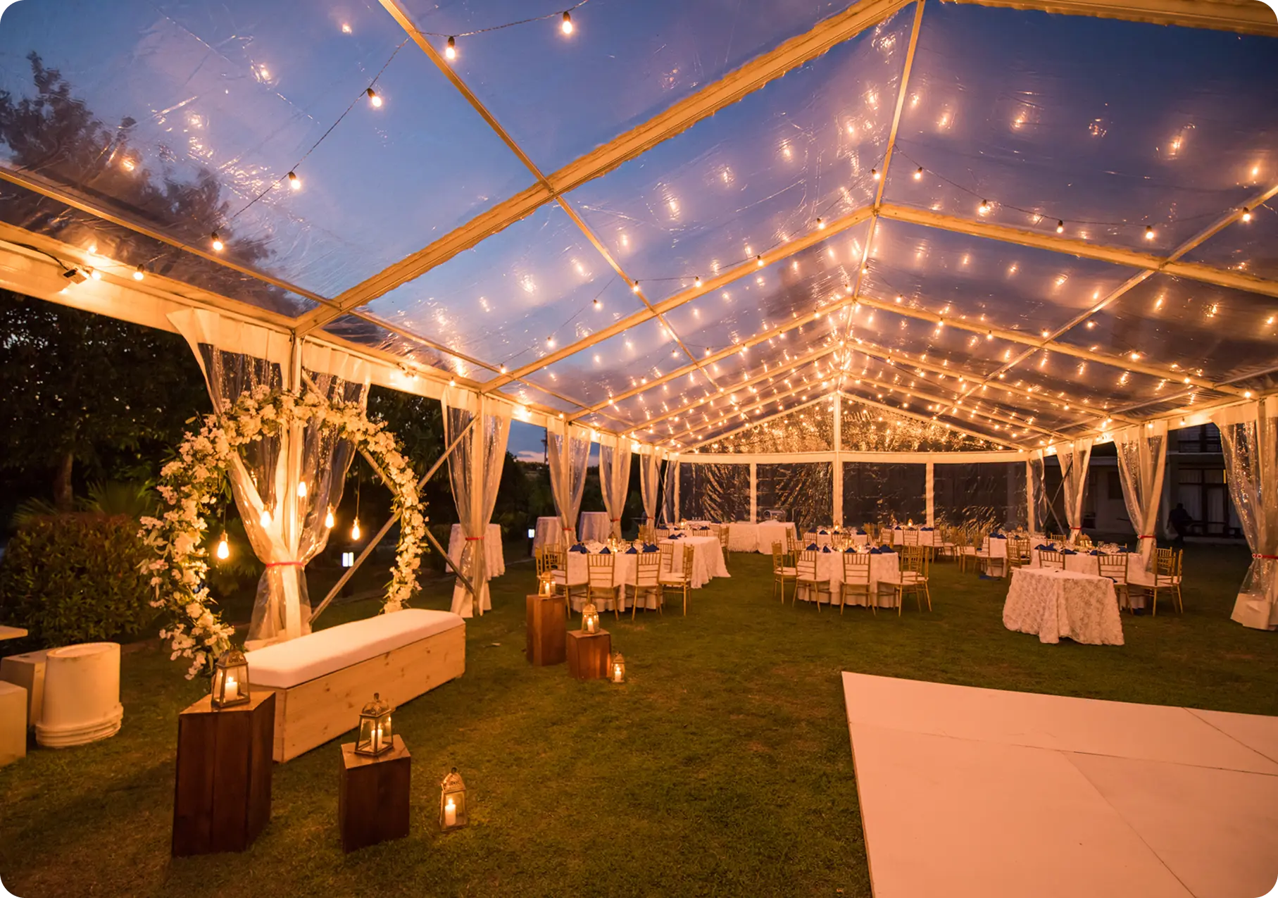 Outdoor wedding reception with string lights.