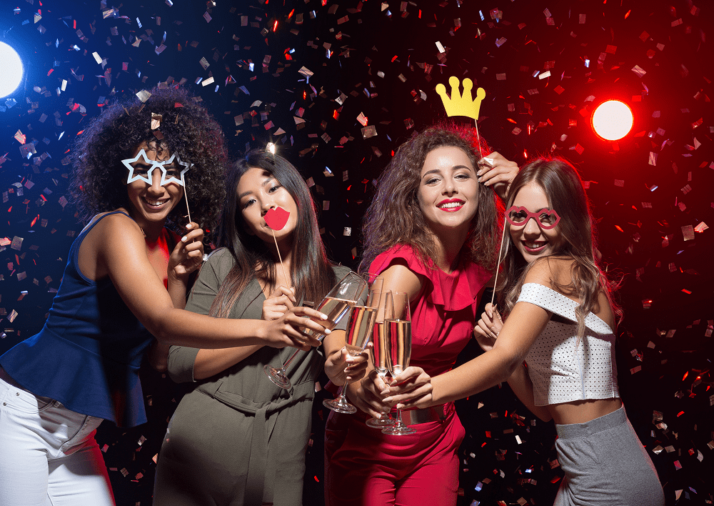 Women celebrating with props and confetti.