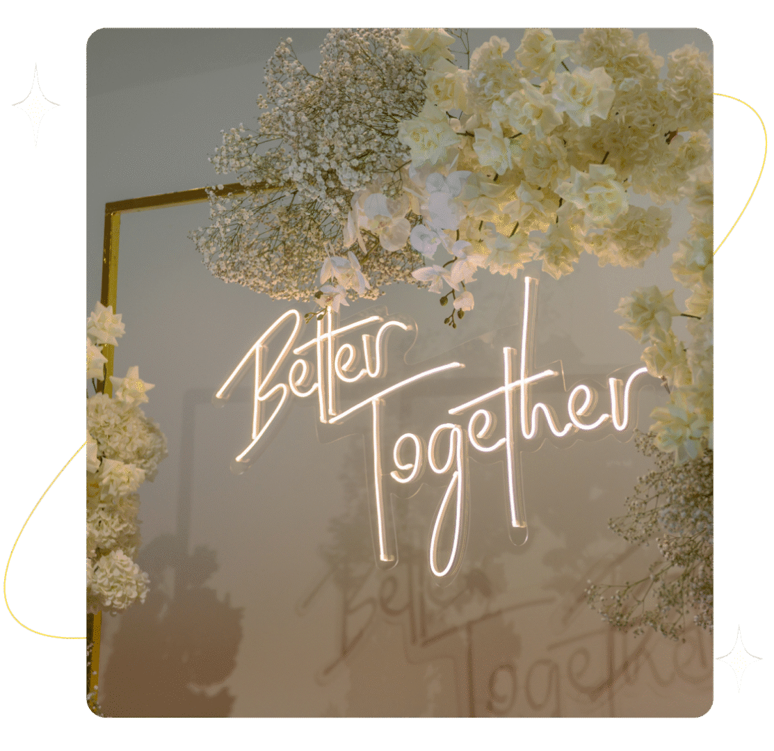 Better Together" neon sign with flowers.
